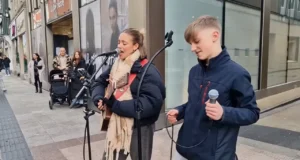 Young street performers, Rhys Mcphillips guitar, Allie Sherlock performance, Elvis Presley cover, Heartbreak Hotel cover, Teenager musician, Street music magic, Live street performance, Young music talents, Busking success stories