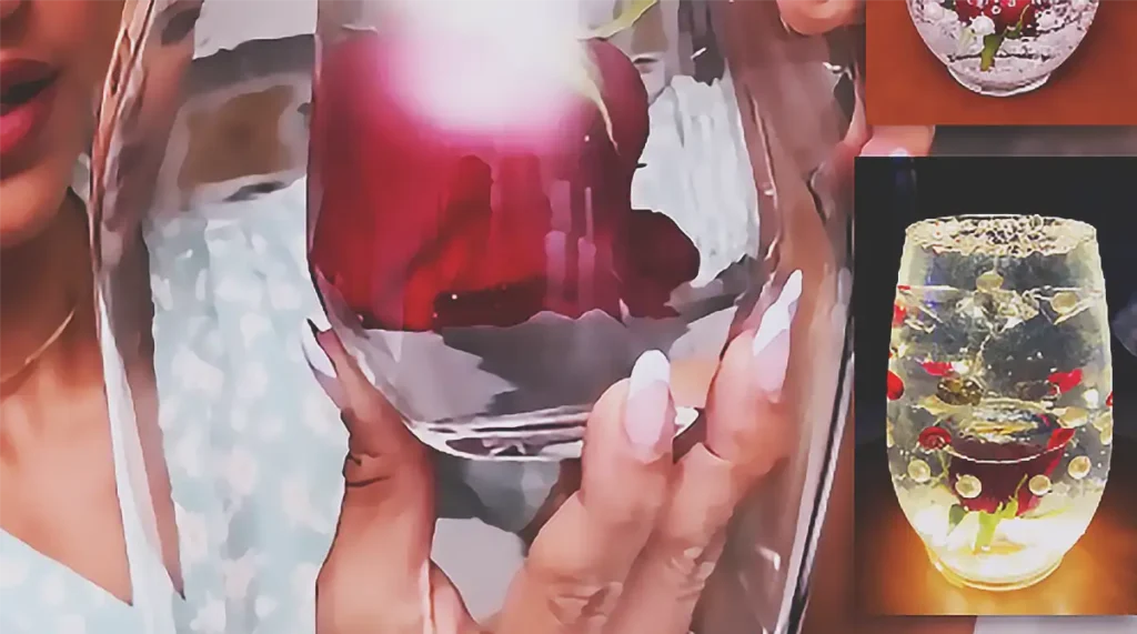 A DIY wedding table centerpiece made with a red flower inside a glass vase with water, styled as a simple elegant floral decoration for wedding or reception tables.